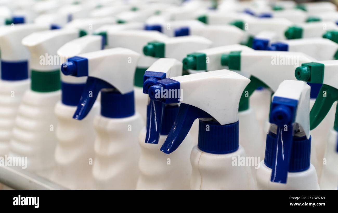 sprayer bottle. Group of white sprayer bottles high angle view. Cleaning equipments concept. Selective focus included. Stock Photo