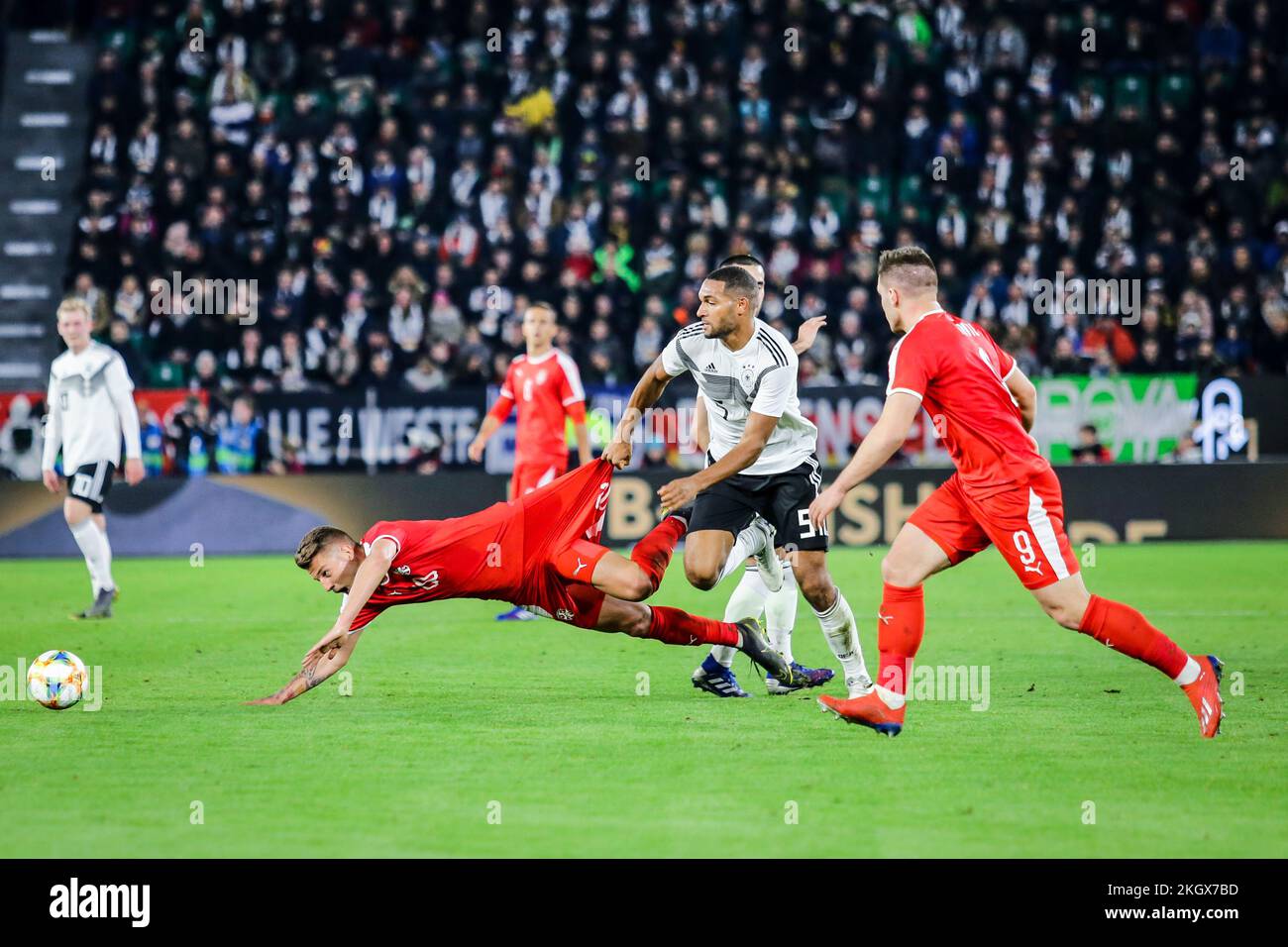 Wolfsburg, Germany, March 20, 2019: footballers Jonathan Tah (GER) and Sergej Milinkovic (SRB) in action during the international soccer game Stock Photo