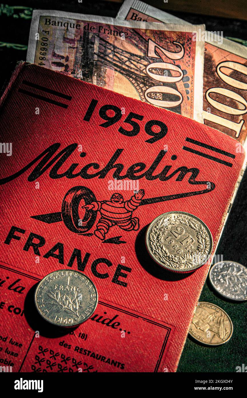 MICHELIN GUIDE 1950’s VINTAGE OLD FRENCH FRANCS CONCEPT Pre-Euro EU Retro style French Francs currency notes and coins on 1959 Michelin Guide France Stock Photo