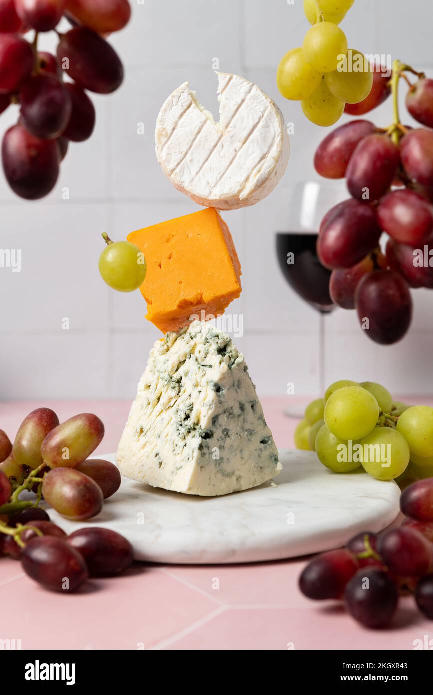 Levitating soft goat cheese, cheddar and blue stilton with red wine and