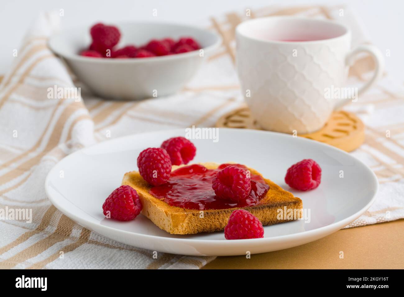 Toast with raspberry jam and cup of tea Stock Photo - Alamy