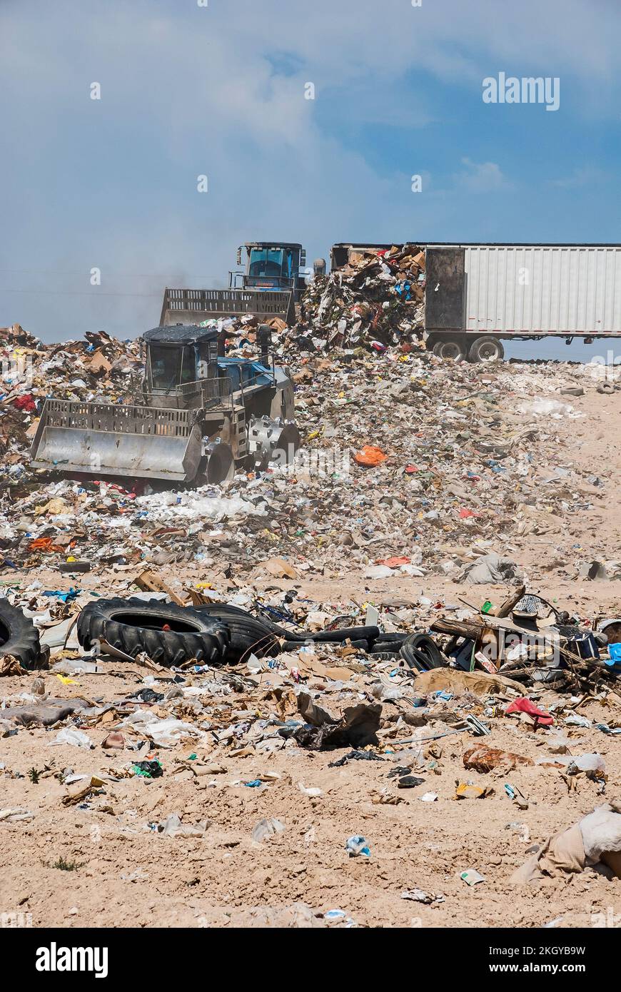 Two soil compactors and a semi trailer on a hill in an active landfill Stock Photo Alamy