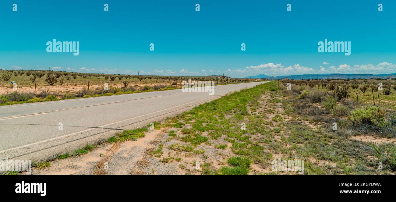 The panoramic view of a road in the desert of Canoncito in New Mexico, USA. Stock Photo