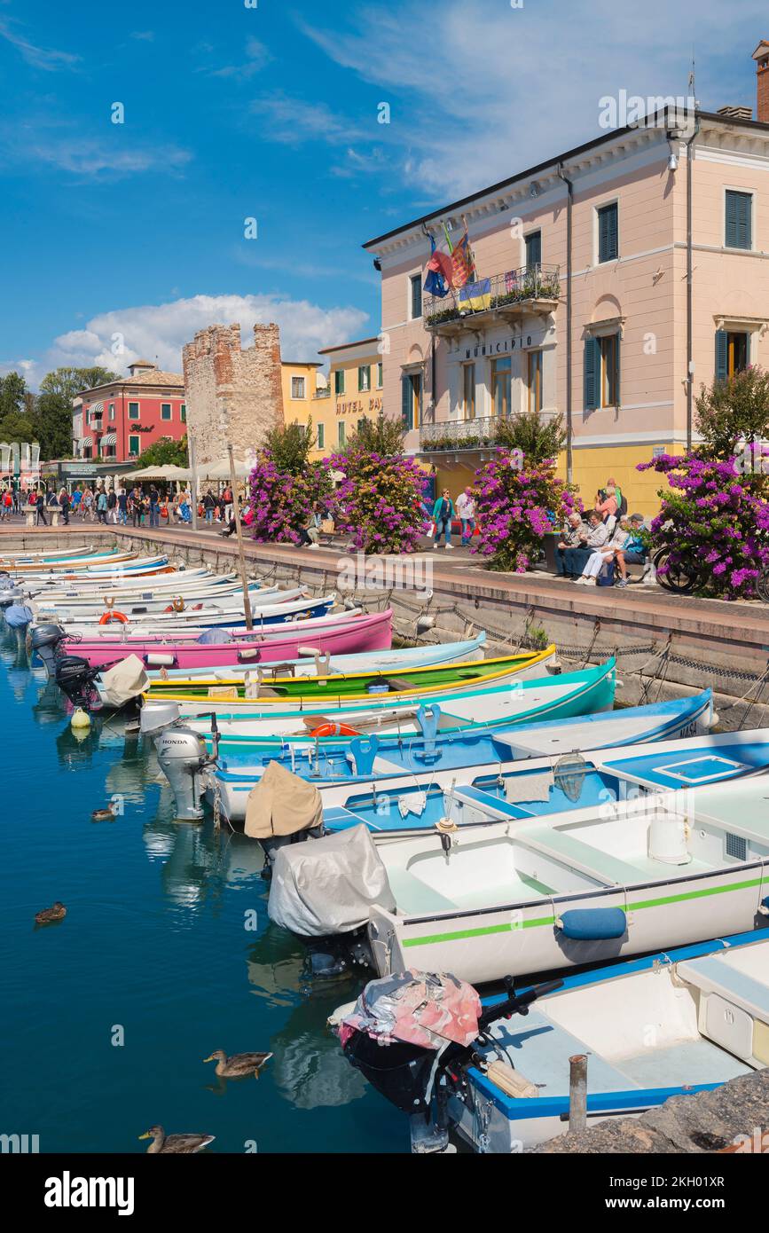 Bardolino Lake Garda, view in summer of the colourful lakeside harbour area - the Lungolago Francesco Lenotti - In Bardolino, Lake Garda, Veneto Italy Stock Photo