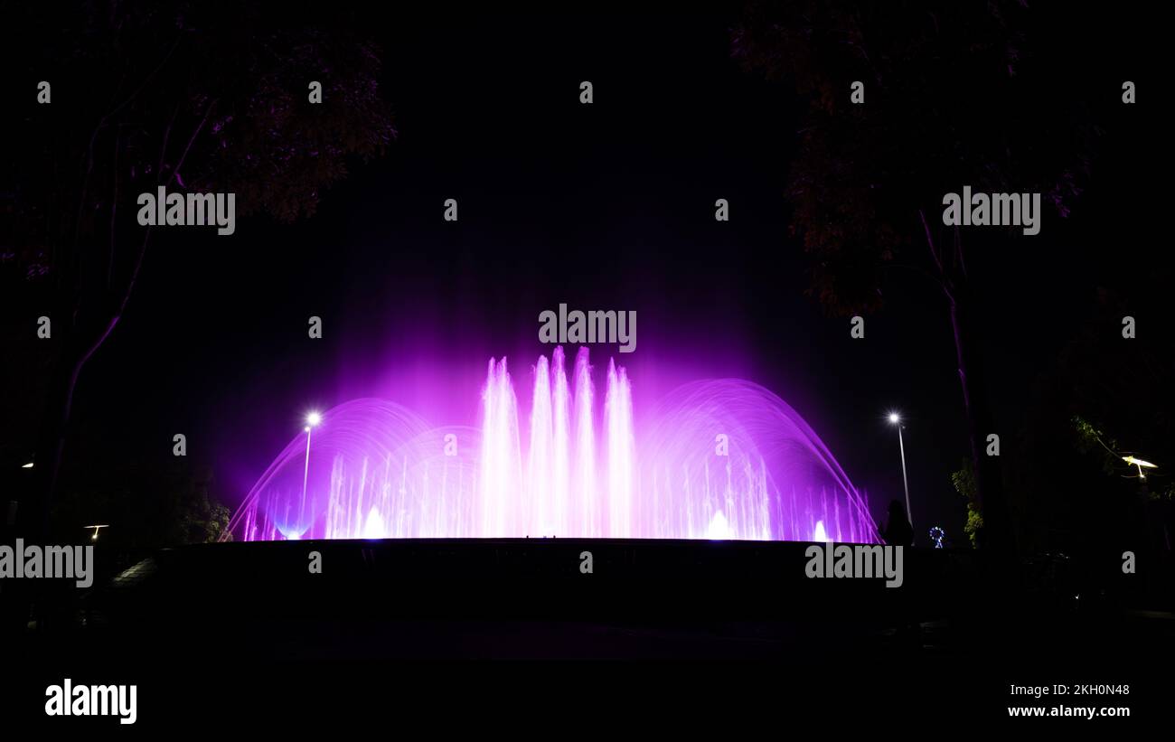 A long exposure shot of an illuminated fountain at night Stock Photo ...