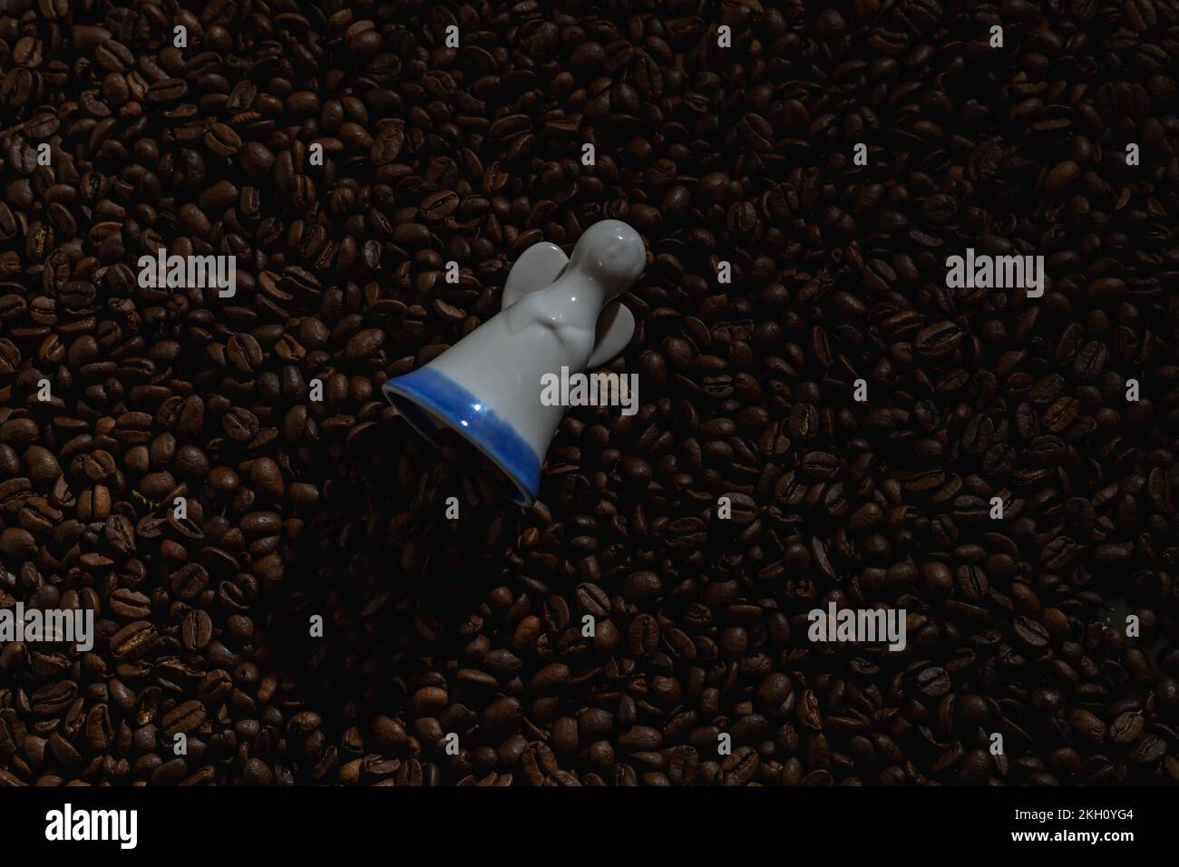 Figurine of an angel on a background of coffee beans Stock Photo