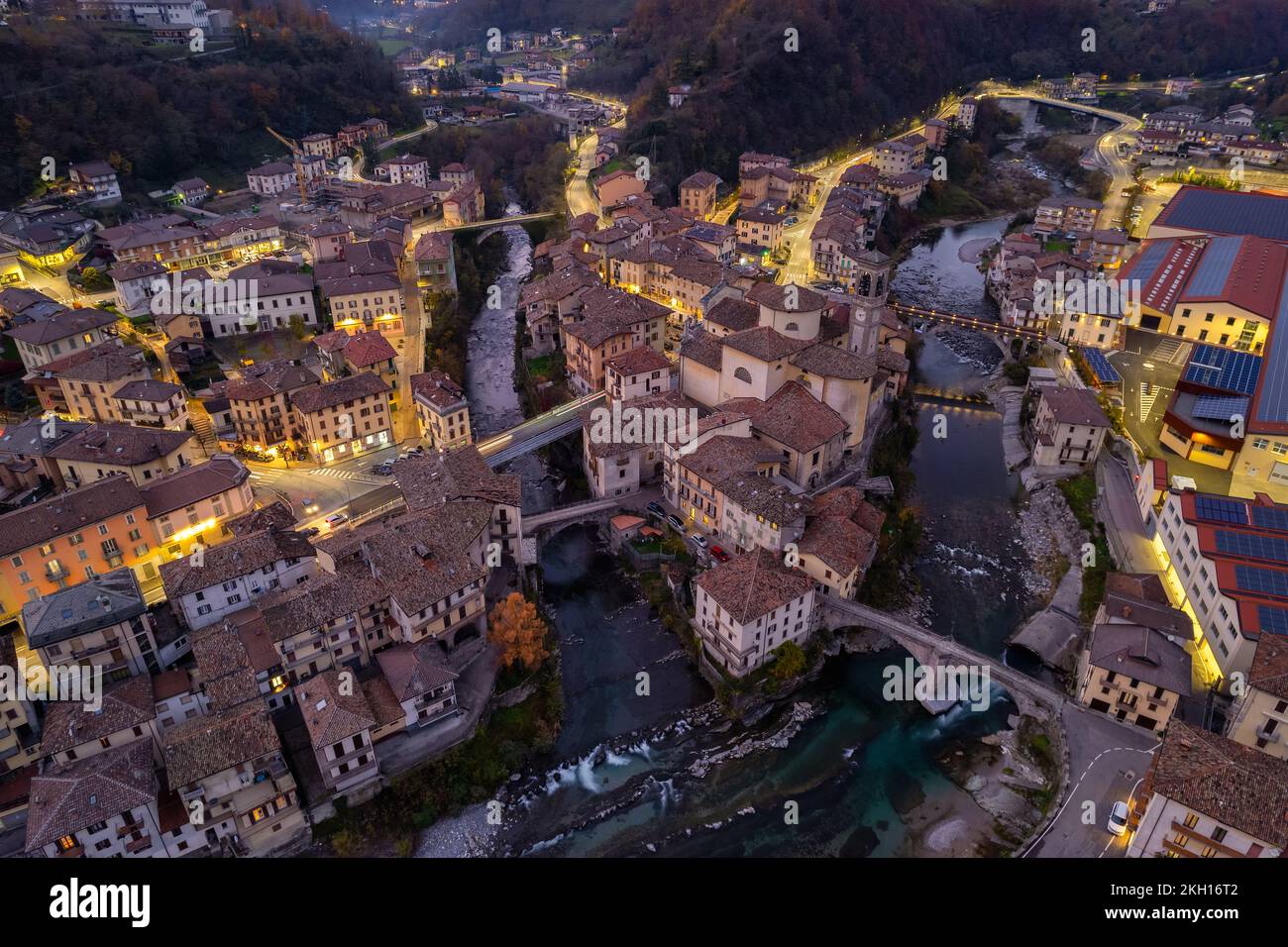 Aerial view of old church and crossing rivers surrounded by Alps mountains, San Giovanni Bianco Village, Valbrembana, Bergamo, Lombardy, Italy Stock Photo