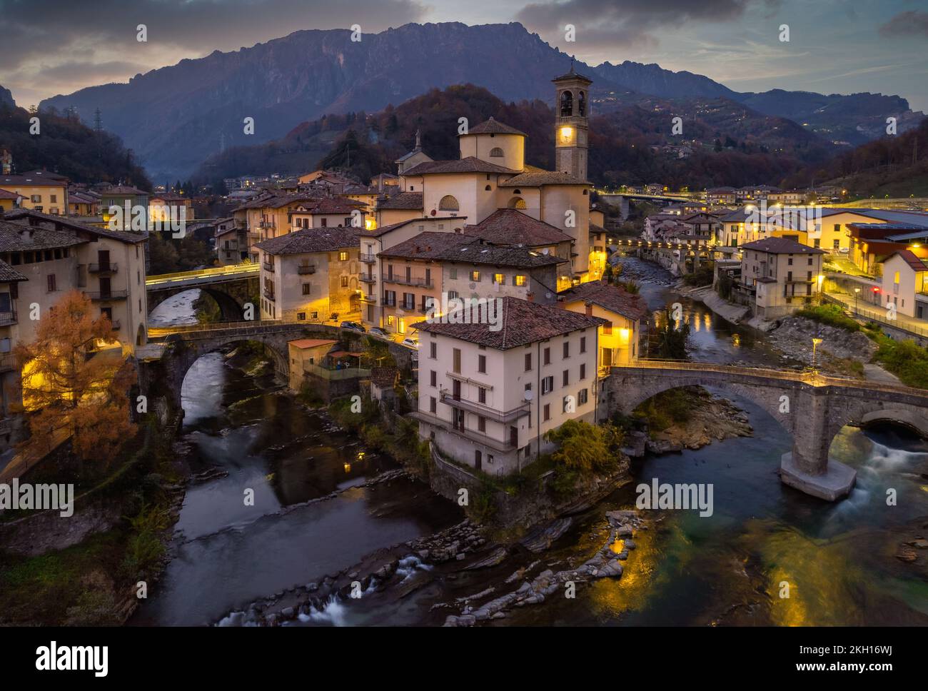 Aerial view of old church and crossing rivers surrounded by Alps mountains, San Giovanni Bianco Village, Valbrembana, Bergamo, Lombardy, Italy Stock Photo