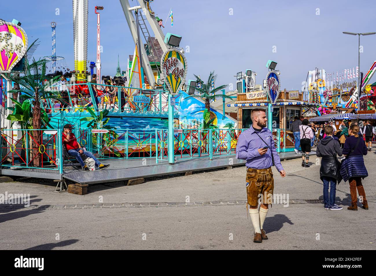 People by a ride at the Oktoberfest. Stock Photo