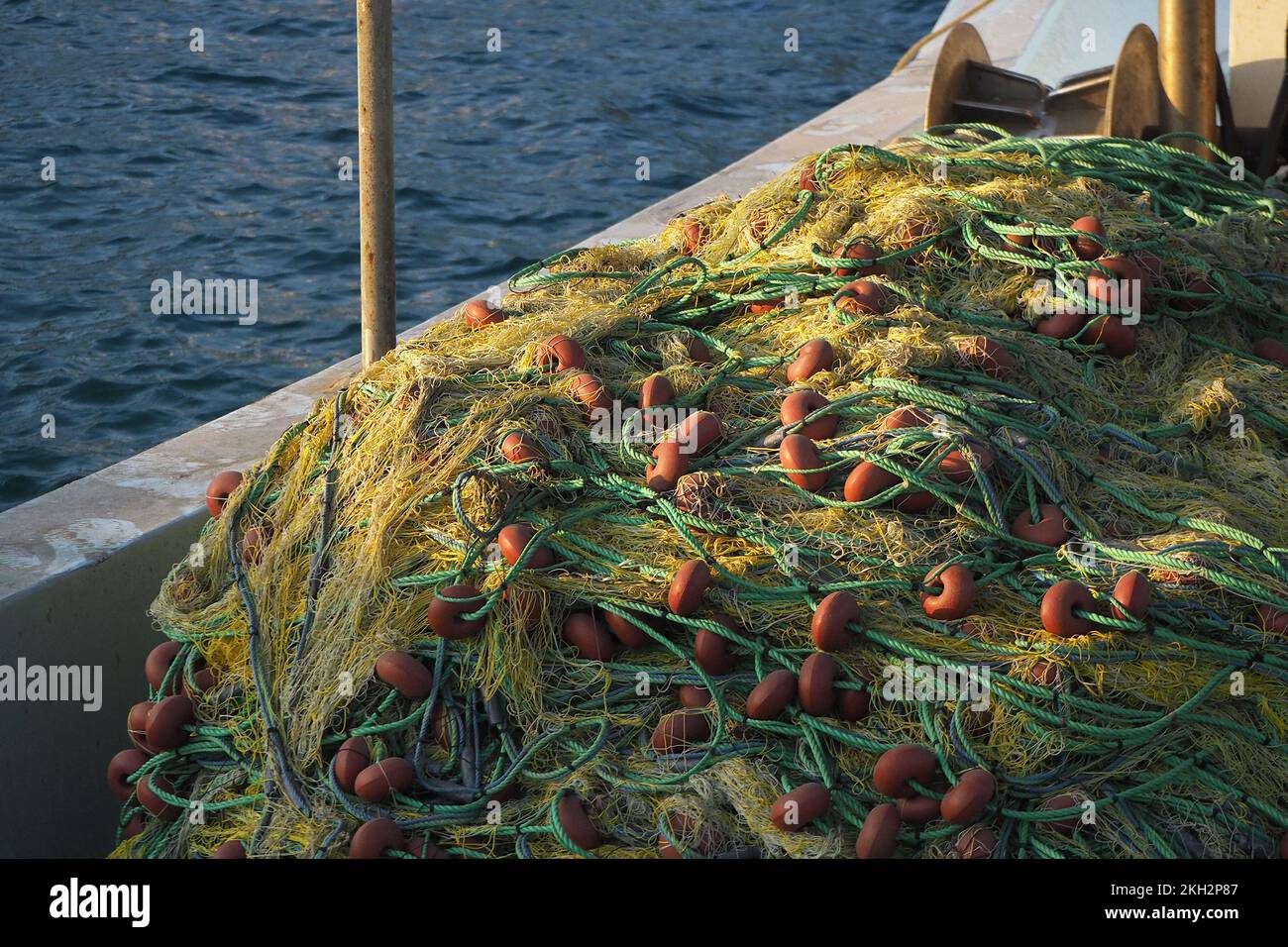 A pile of nets and floats on a fishing boat. Fishing net stack with its