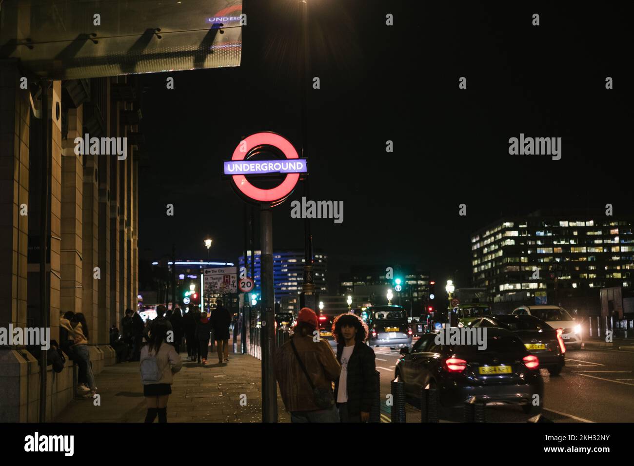 London, UK - November 4, 2022: Tube station logo in London city evening lights. Stock Photo