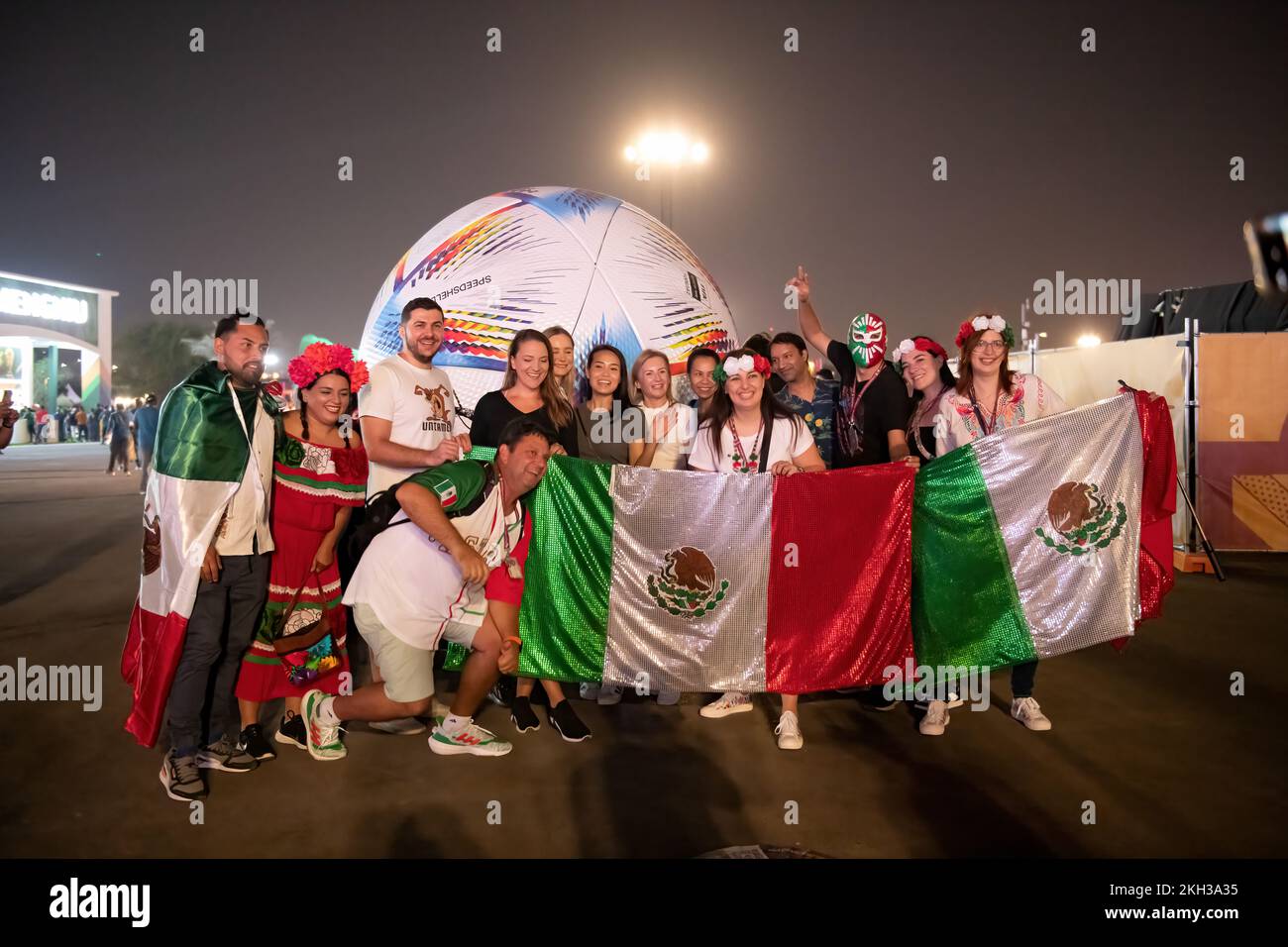 Soccer fans celebrating opening ceremony in Doha Fan Zone Qatar. Mexicans Football Fans in Qatar Stock Photo