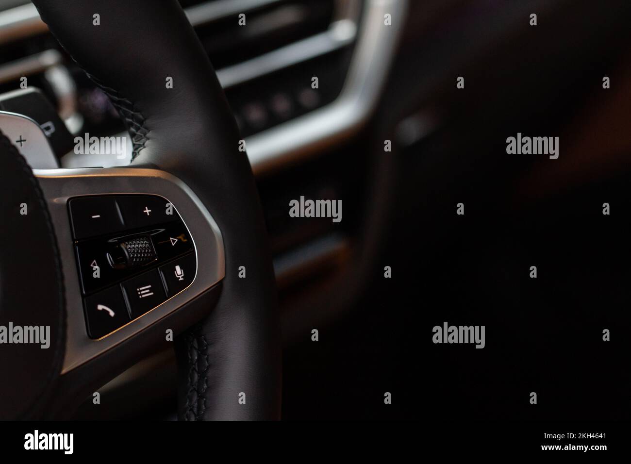 Call buttons on car steering wheel. Audio control buttons on the steering wheel of a modern car. Stock Photo
