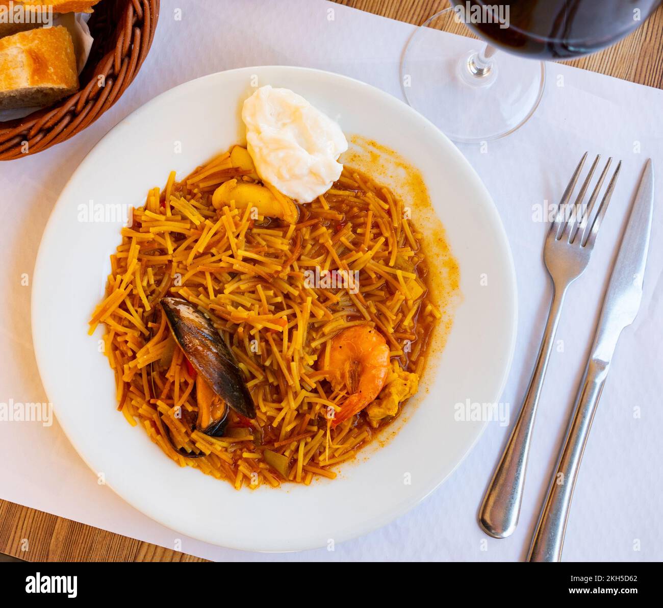 traditional-spanish-seafood-dish-fideua-with-aioli-sauce-in-restaurant