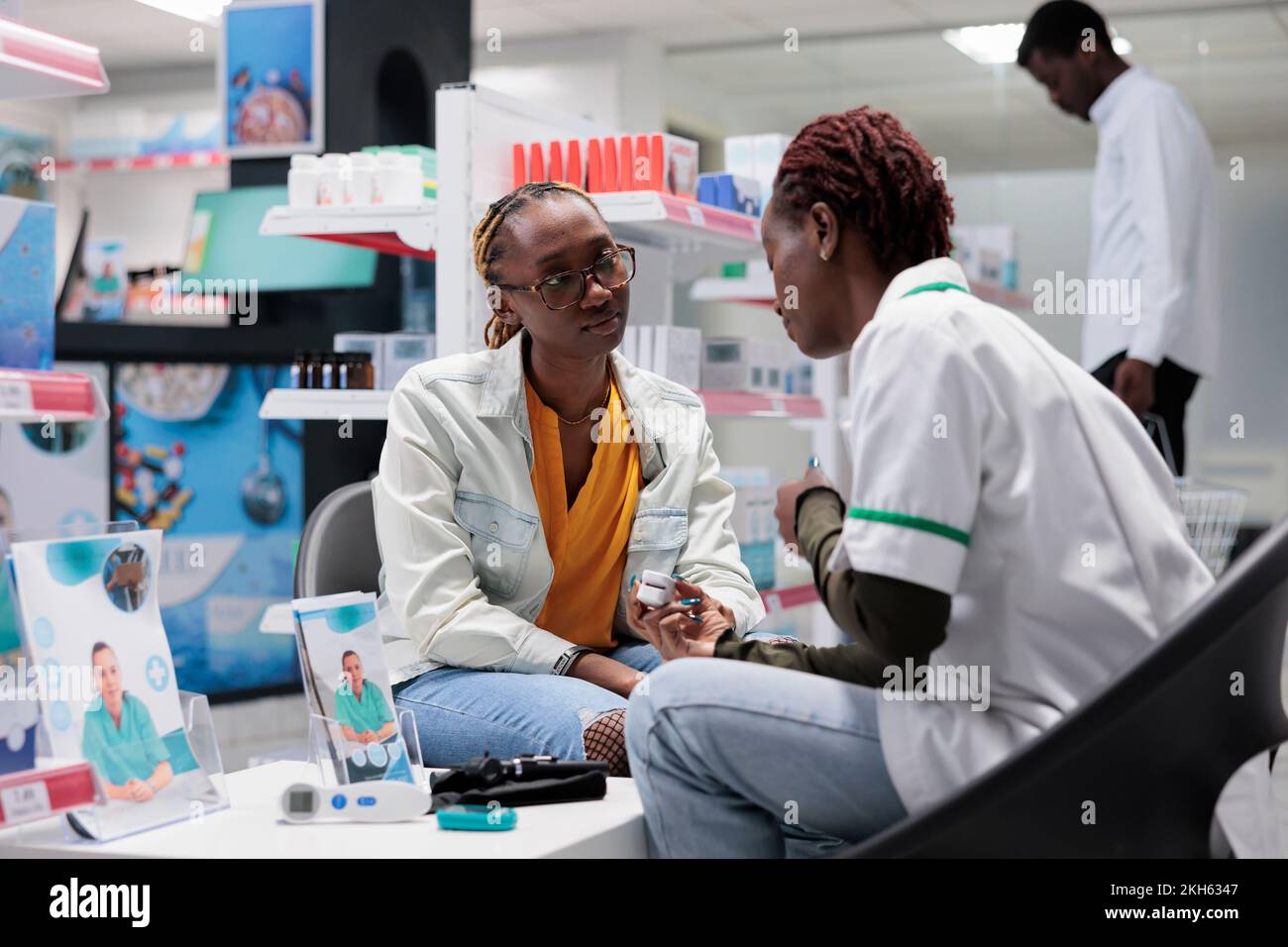 Pharmacy consultation, pharmacist using pulse oximeter, measuring