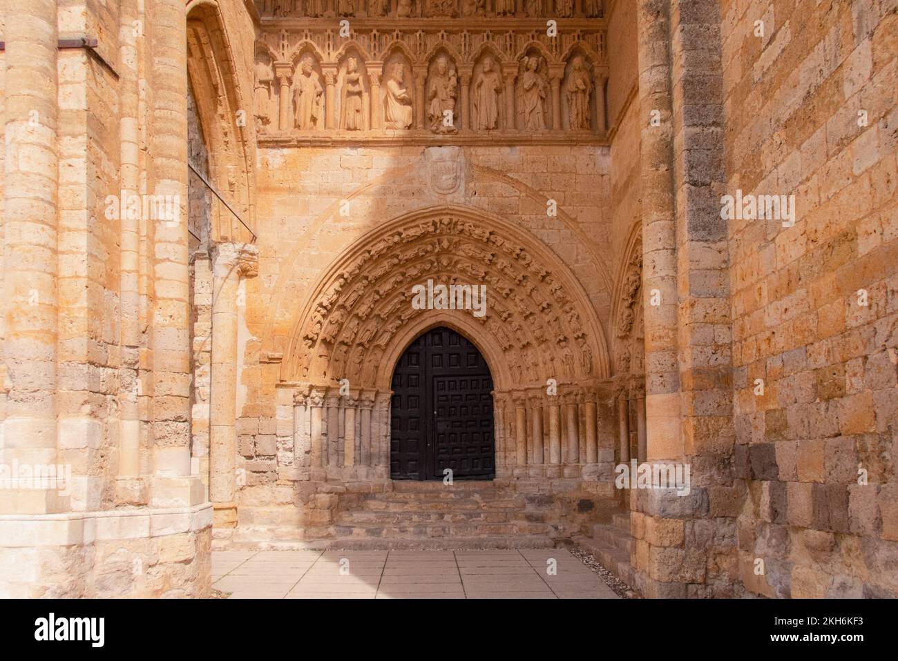 The richly decorated porch of the church Iglesia de Nuestra Señora de la Virgen Blanca in Villalcázar de Sirga. The church was built in the 12th and 13th century by the order of the Knights Templar. Stock Photo