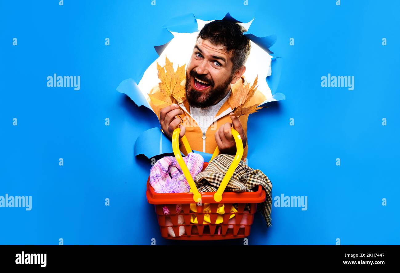 Autumn clothing. Bearded man with shopping basket. Warm clothes. Advertise for store or supermarket. Stock Photo