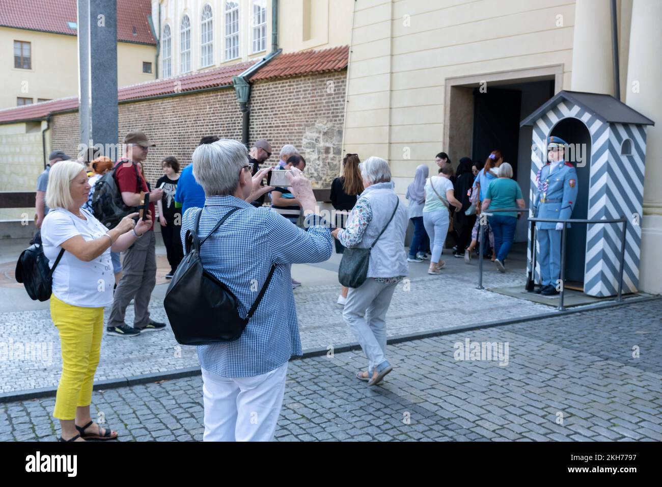 Prague, Czech Republic - 4 September 2022: Tourists taking pictures of a Prague Castle Guard Stock Photo