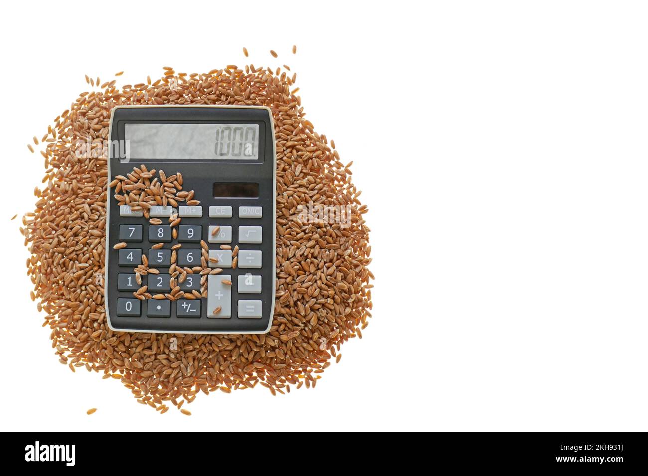 Wheat grains and a calculator on a white background.Economic concept.Growth in world prices for wheat and flour Stock Photo