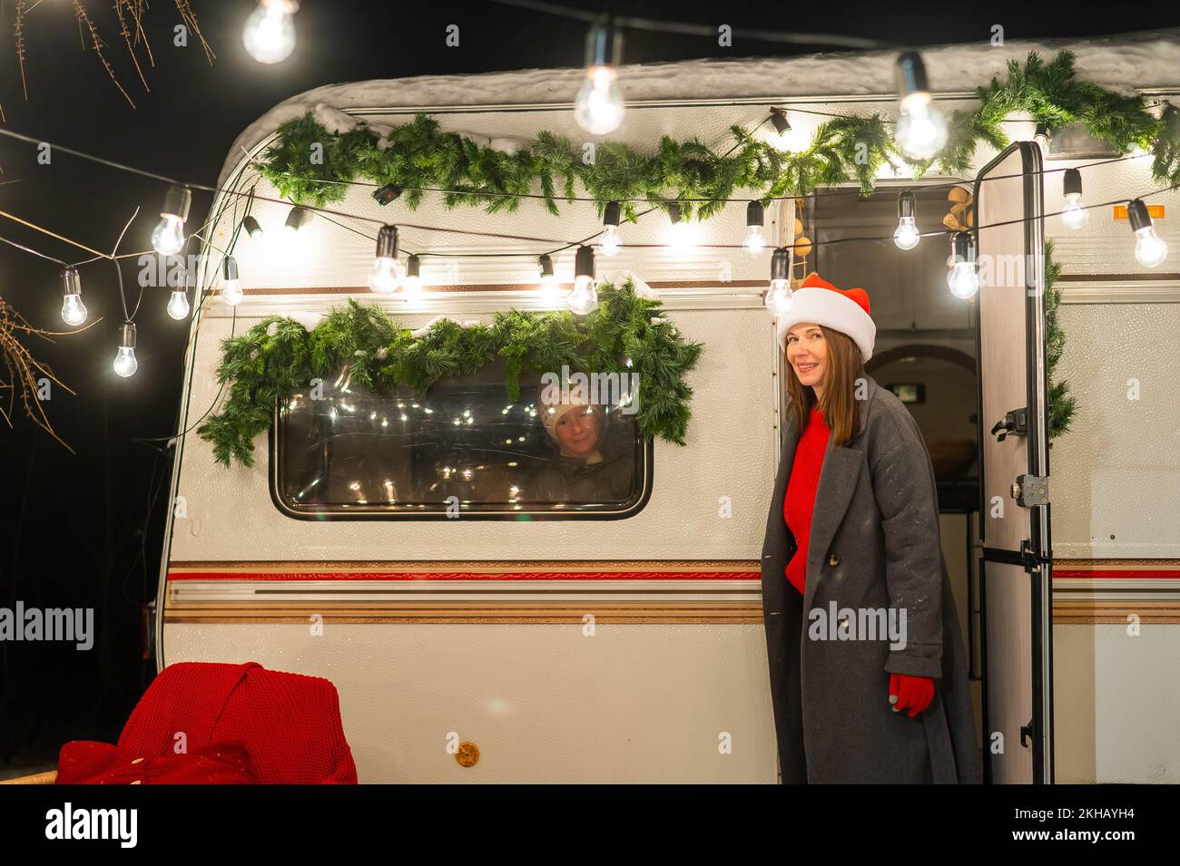 Caucasian woman and two with sons celebrate Christmas in a camper. Mom