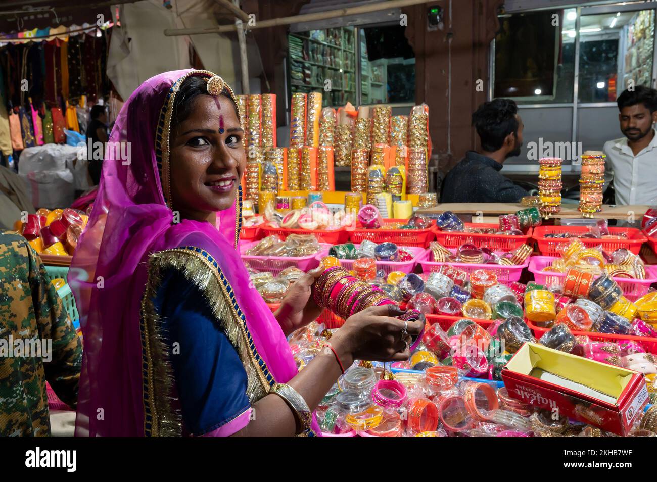 Jodhpur, Rajasthan, India - 18.10.2019 : Smiling Rajasthani woman trying out colorful bangles. Bangles being sold at famous Sardar Market and Ghanta g Stock Photo