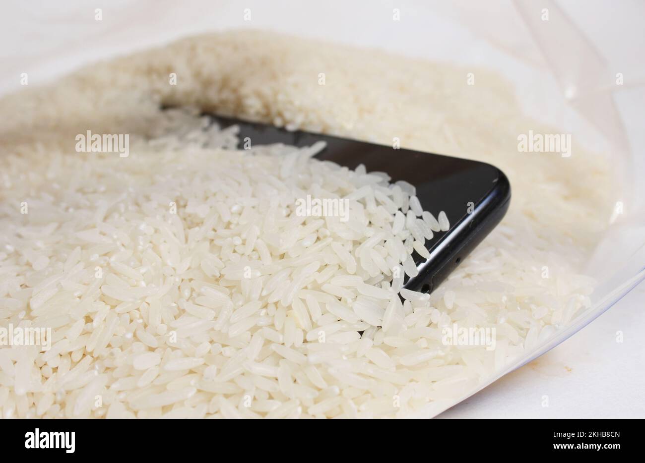 Smartphone in Bag of Rice to remove water from phone Stock Photo
