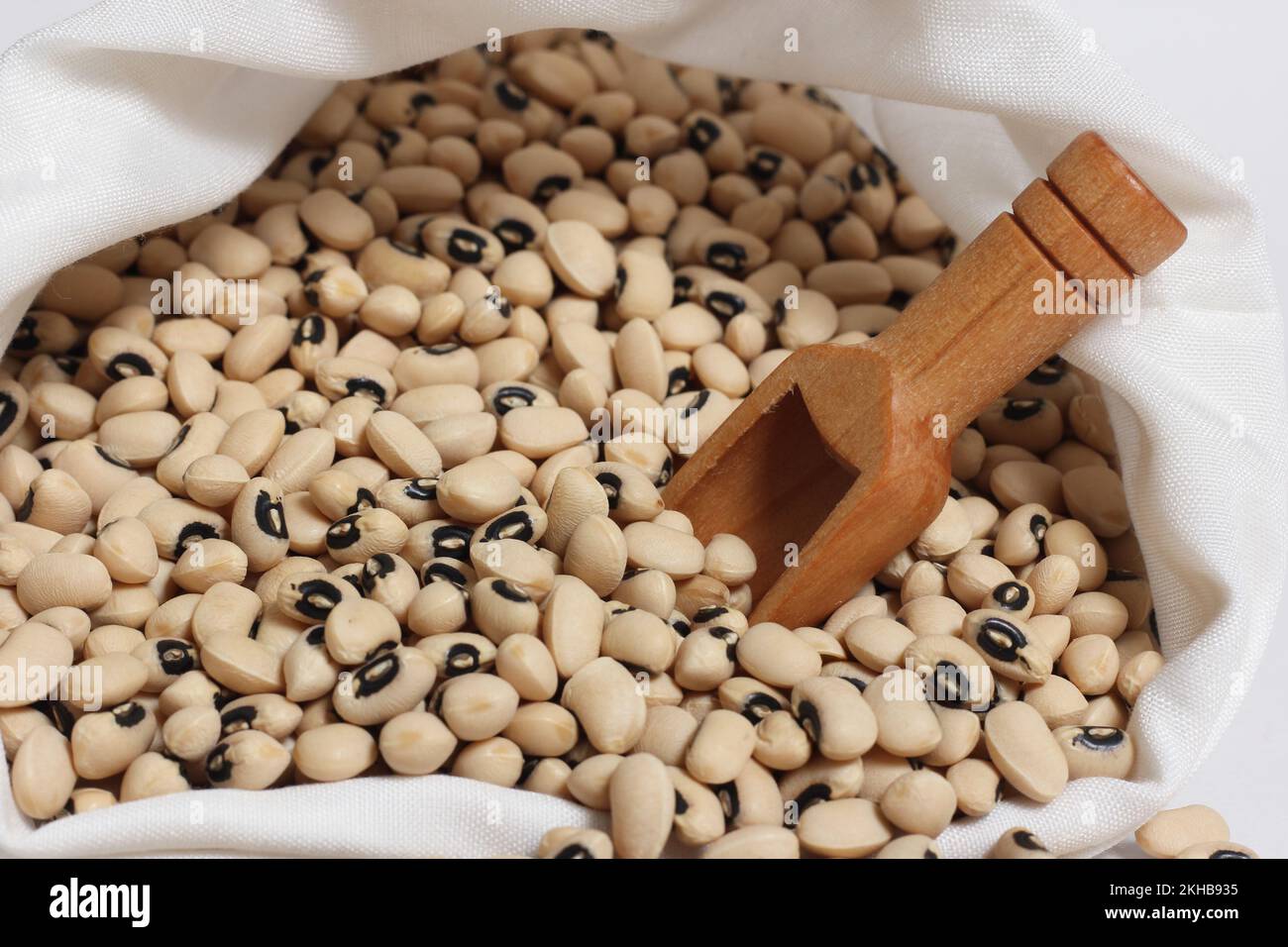 Uncooked Dried Black Eyed Peas in Bag With Wooden Scoop Stock Photo