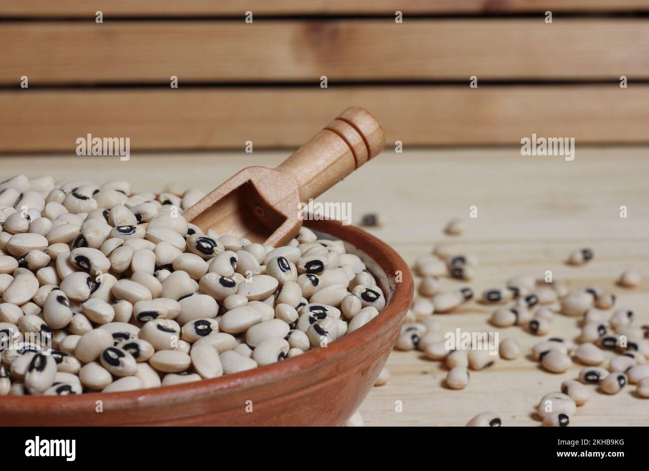 Uncooked Dried Black Eyed Peas in Bowl on Wooden Table Stock Photo