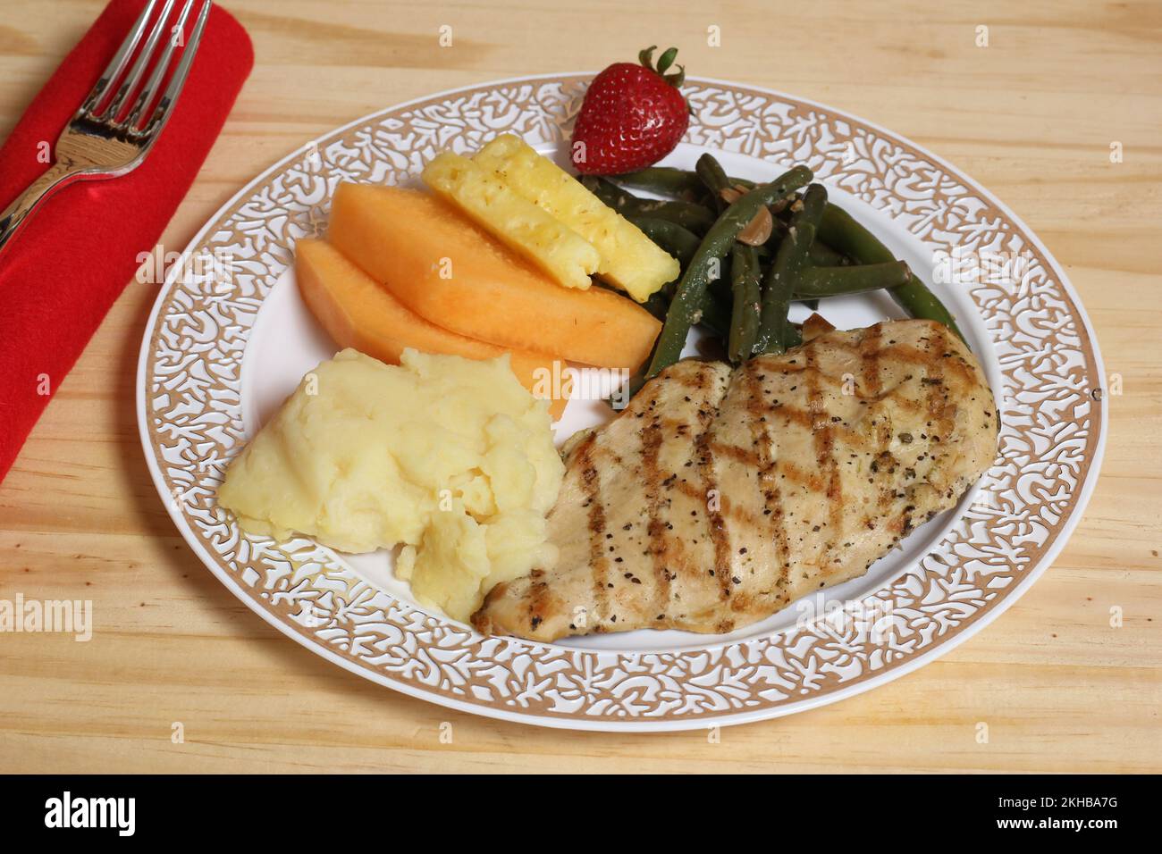 Grilled Chicken and Vegetable Dinner With Fruit at Wedding Stock Photo