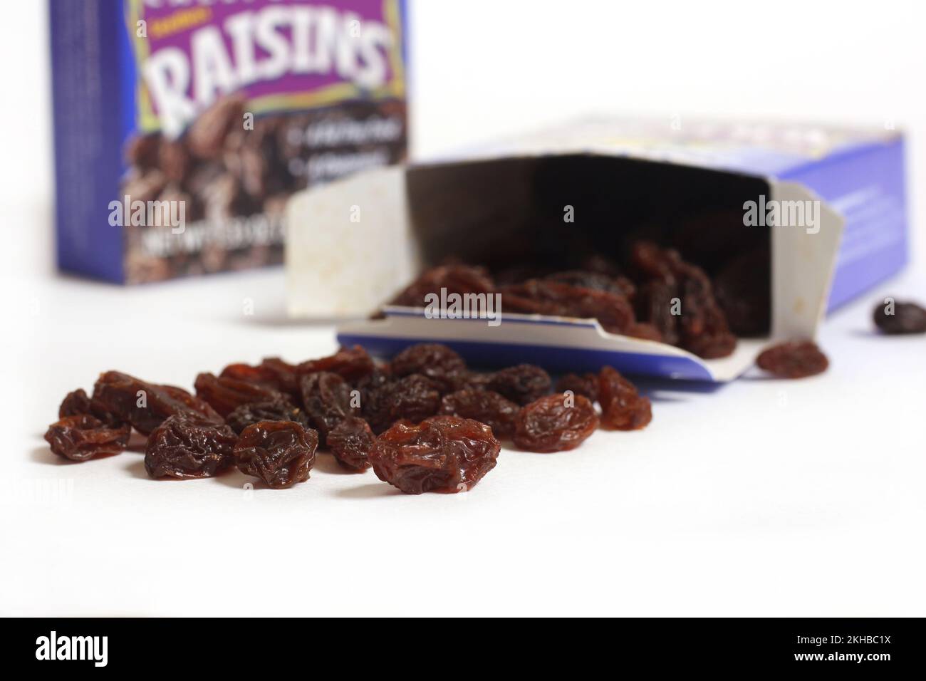 Pile of Raisins With Box Isolated on White Stock Photo