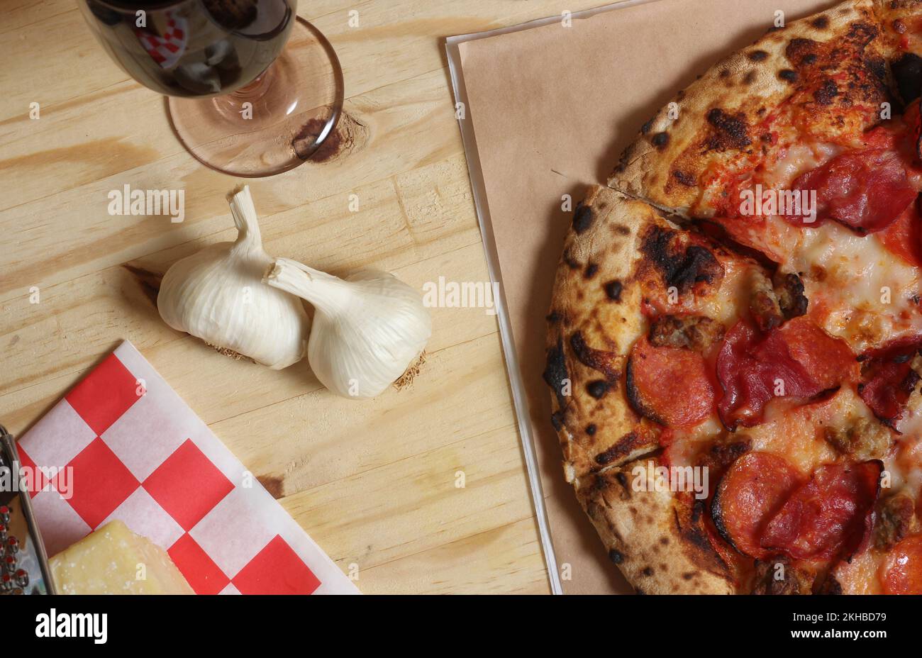Fresh Pizza on Wooden Table at Restaurant Sliced and Ready to Enjoy Stock Photo
