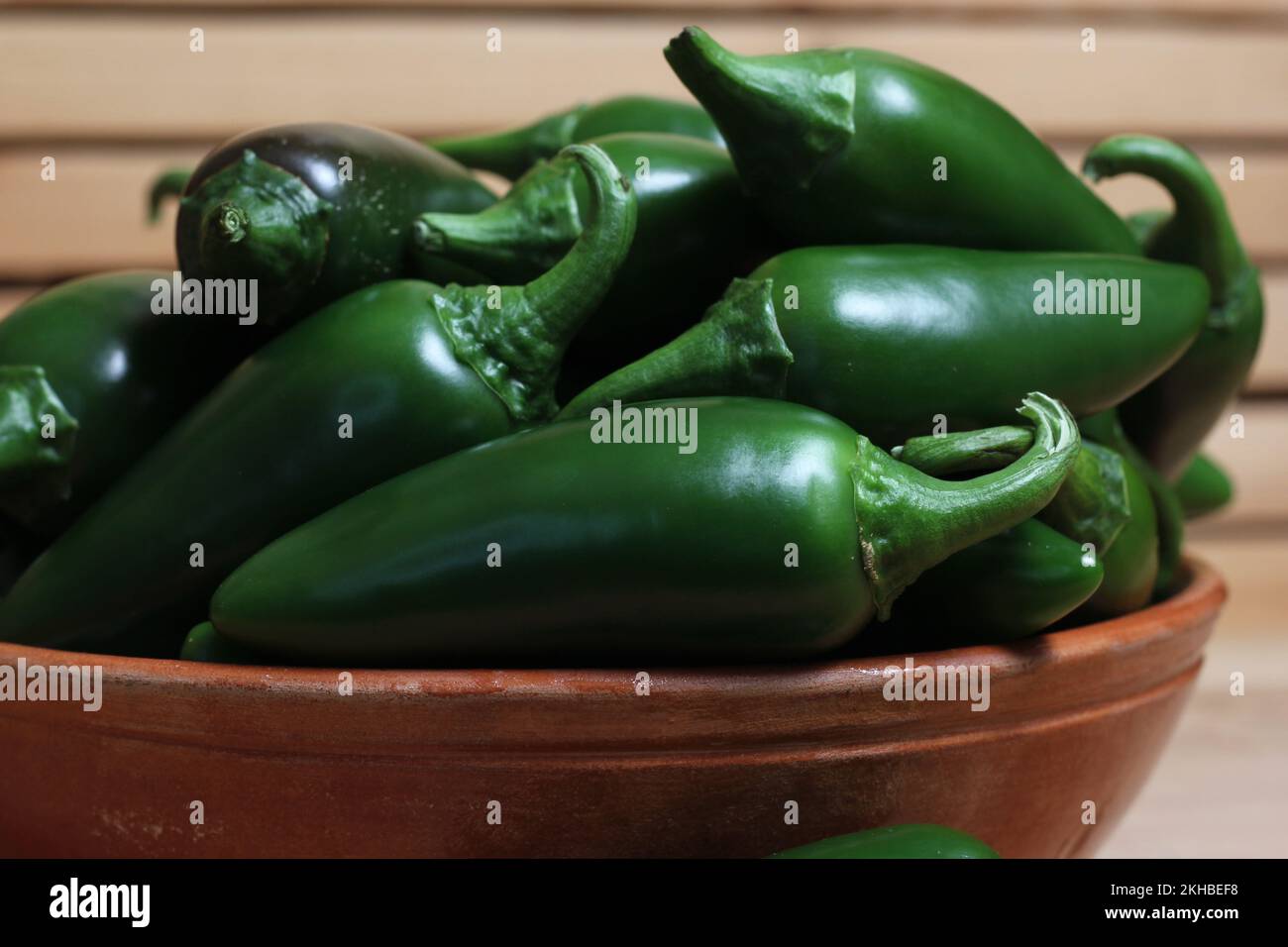 Bowl of Fresh Green Jalapeno Chili Peppers in Rustic Kitchen Stock Photo