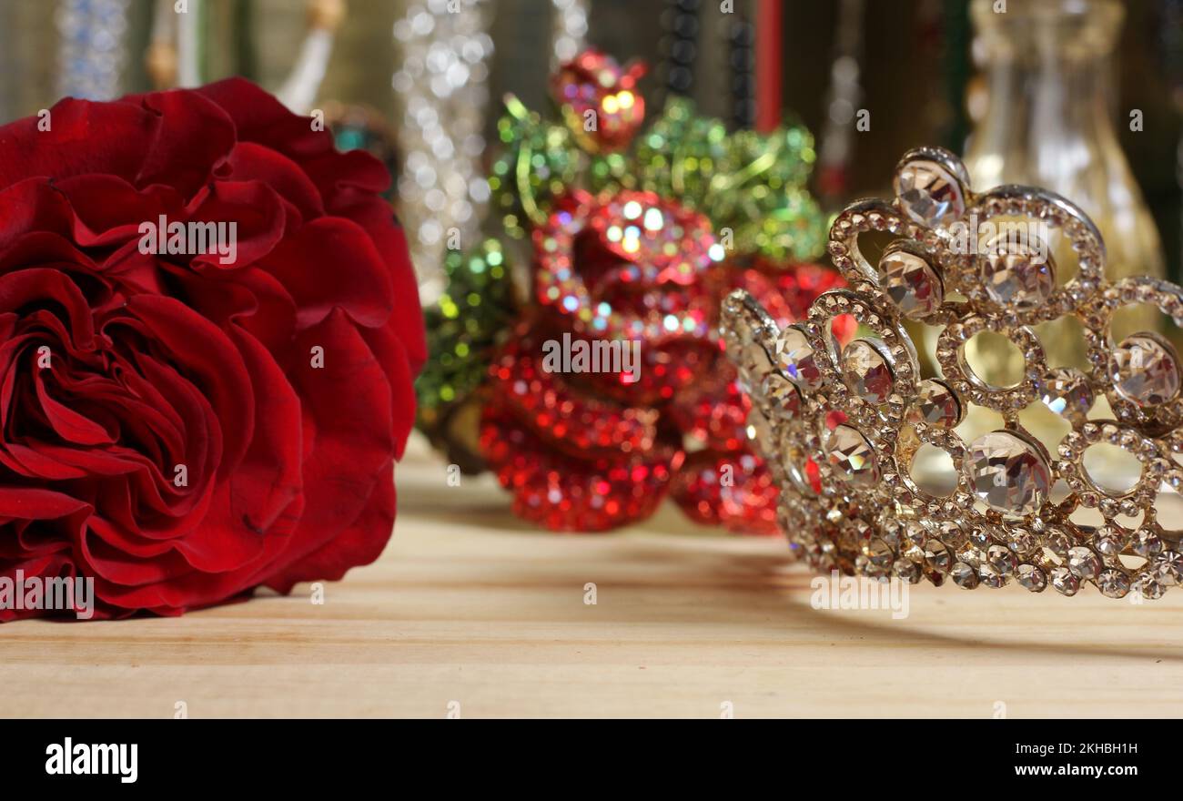 Rose and Tiara with Perfume and Jewelry in Background Shallow DOF Stock Photo