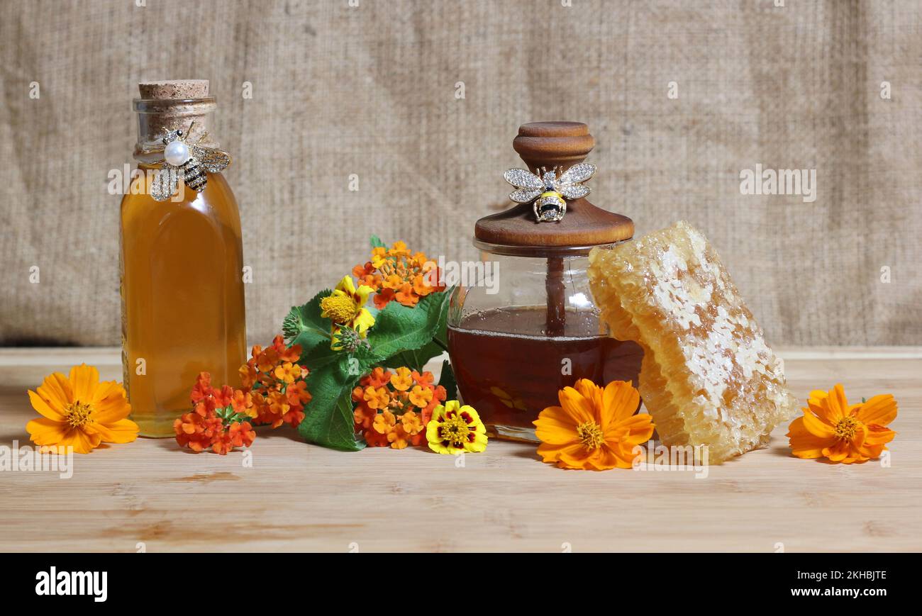 Fresh Honey With Honeycomb and Yellow Flowers in Rustic Kitchen Stock Photo