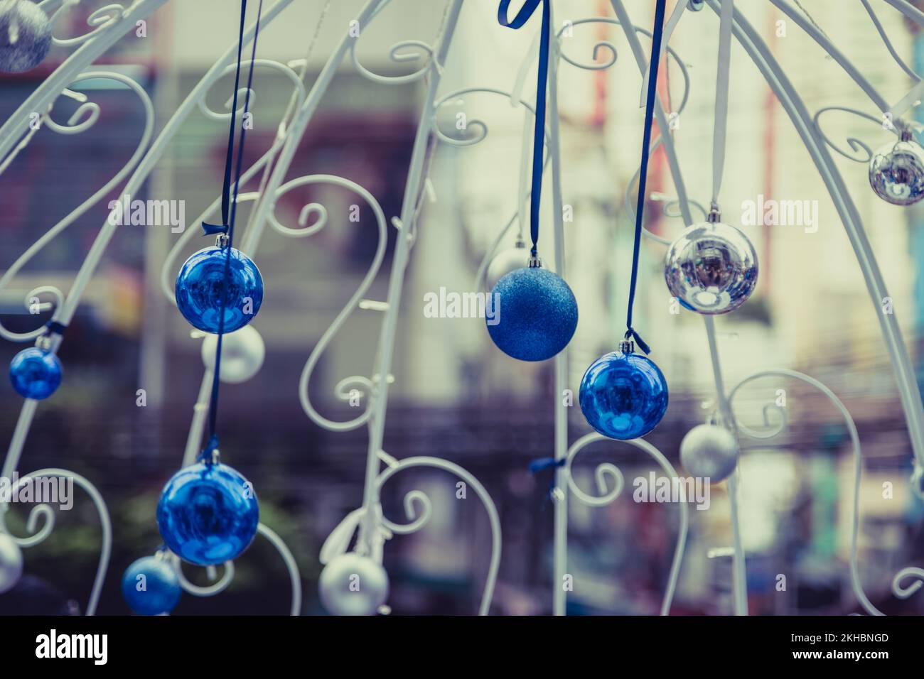 Christmas balls hanging on ribbon with bokeh background Stock Photo - Alamy