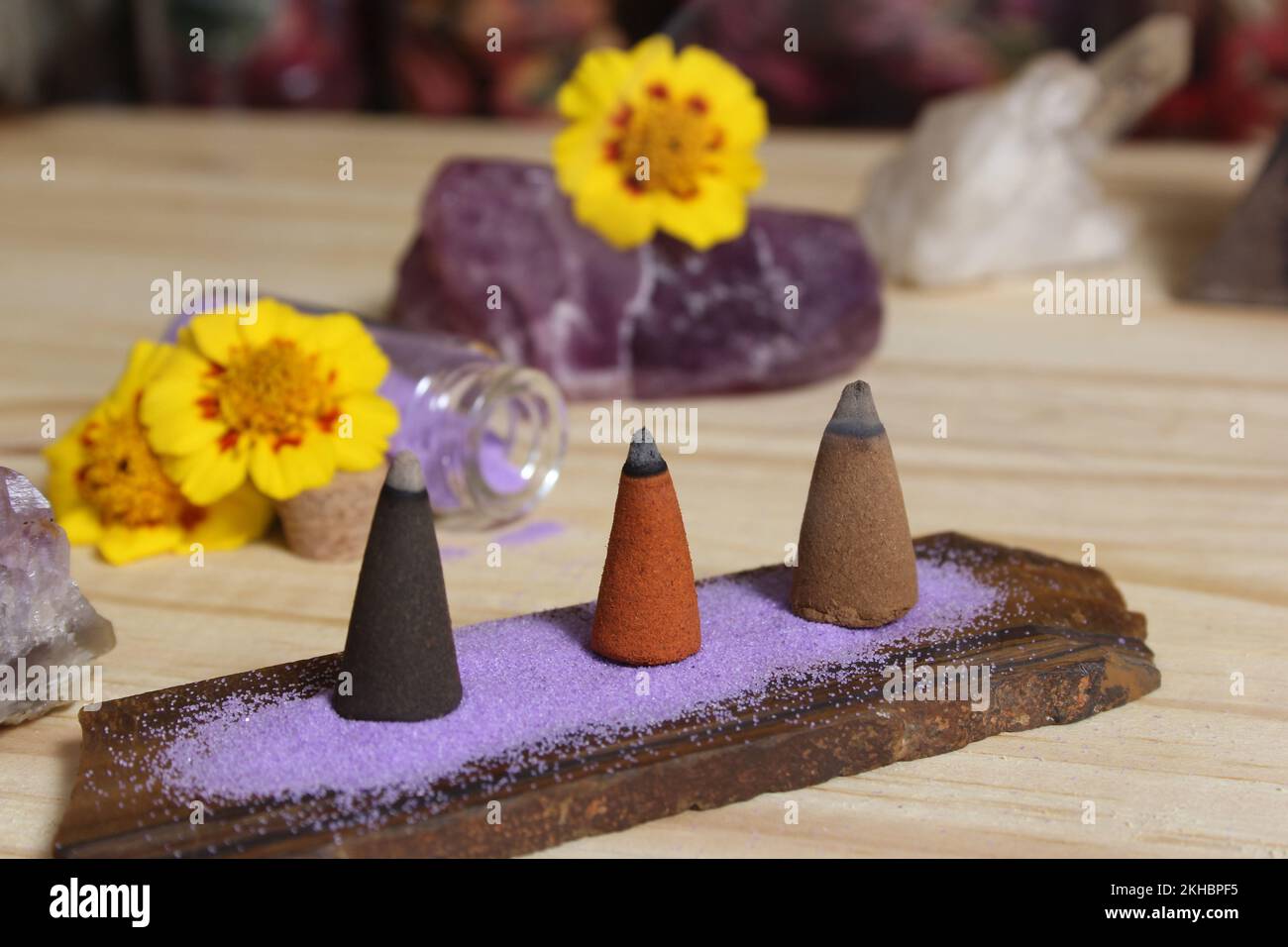 Incense Cones on Stone Slab With Rock Crystals and Flowers Stock Photo