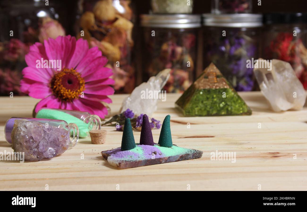 Incense Cones on Stone Slab With Chakra Crystals and Flowers Stock