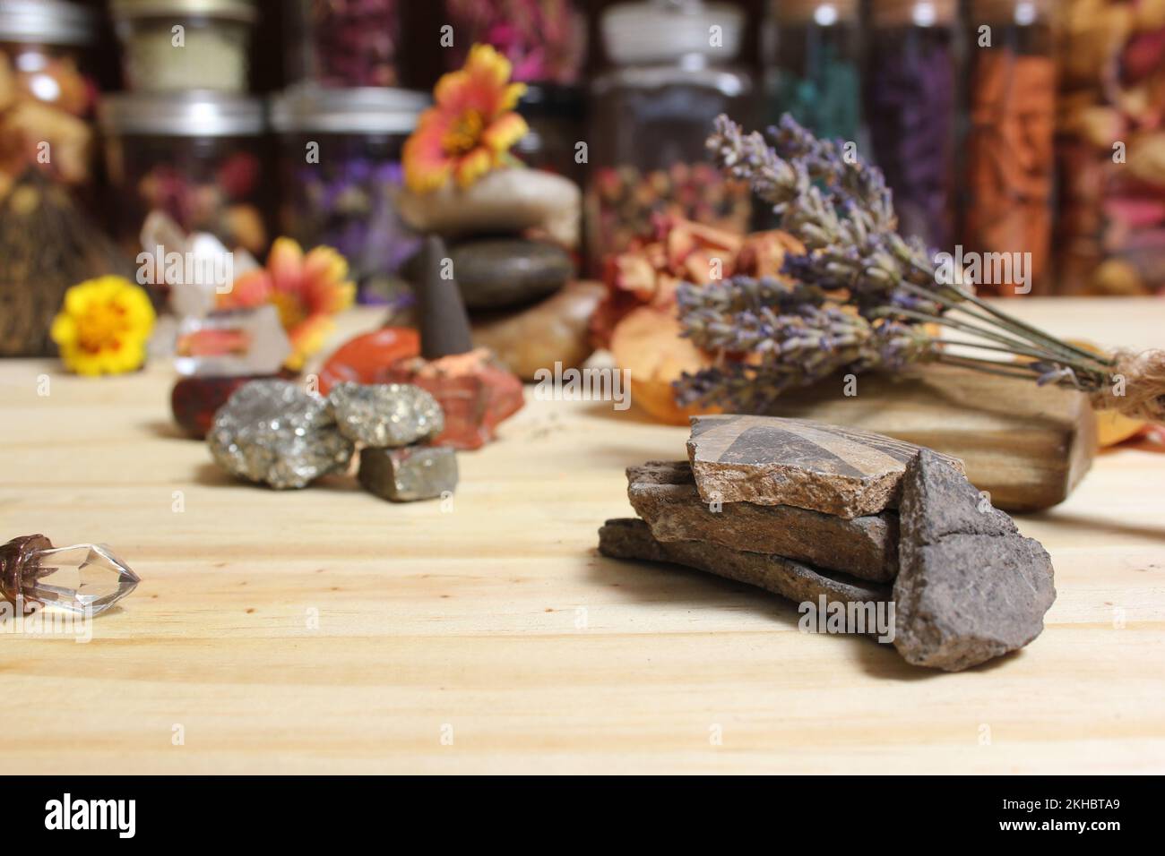Ancient Native American Pottery Pieces With Crystals and Flowers on Meditation Altar Stock Photo
