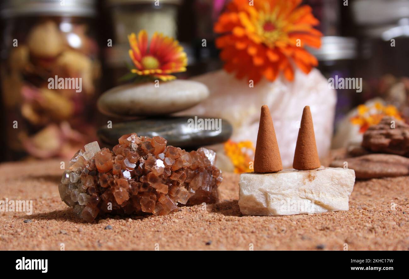 Aragonite Crystals With Incense Cones on Australian Red Sand Stock Photo