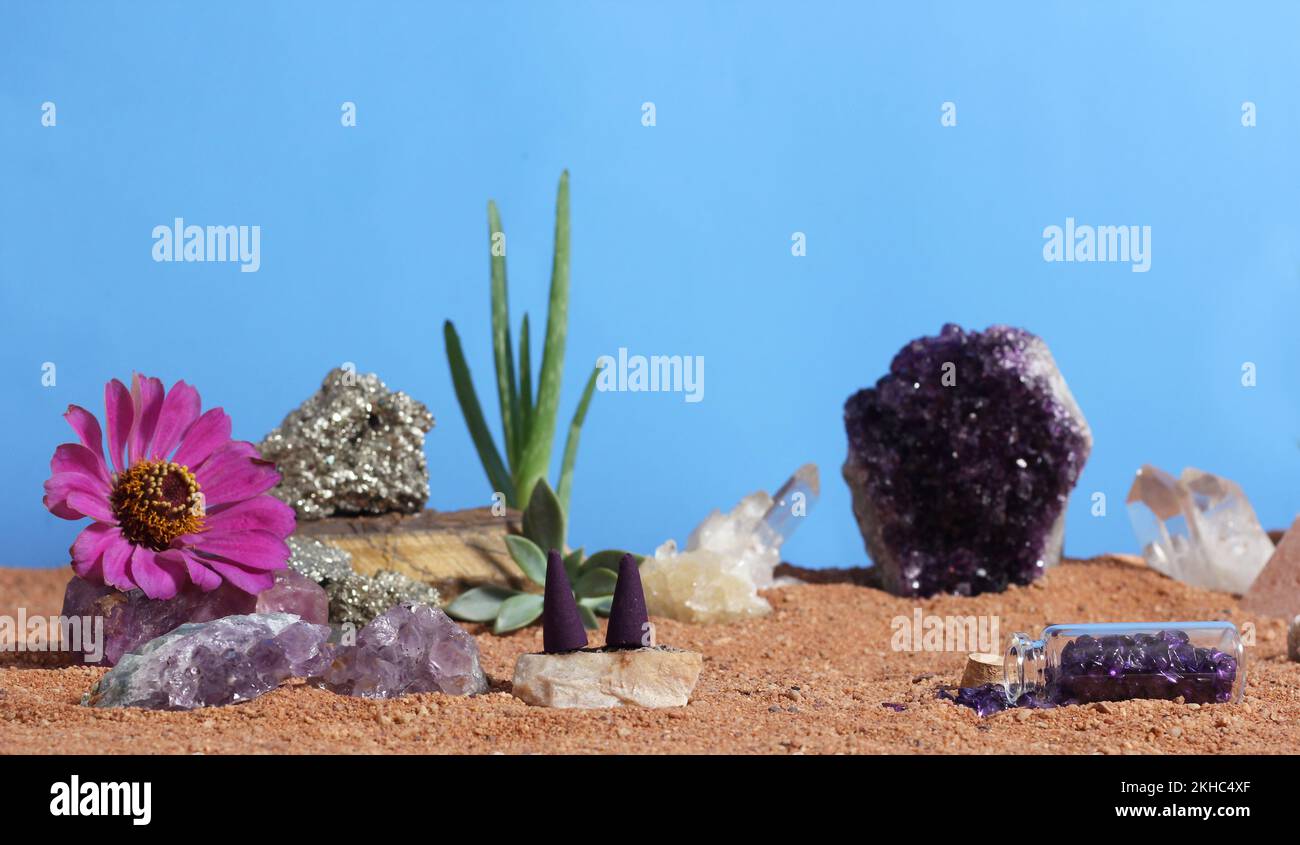 Chakra Stones and Flowers on Australian Red Sand Meditation Altar Stock Photo