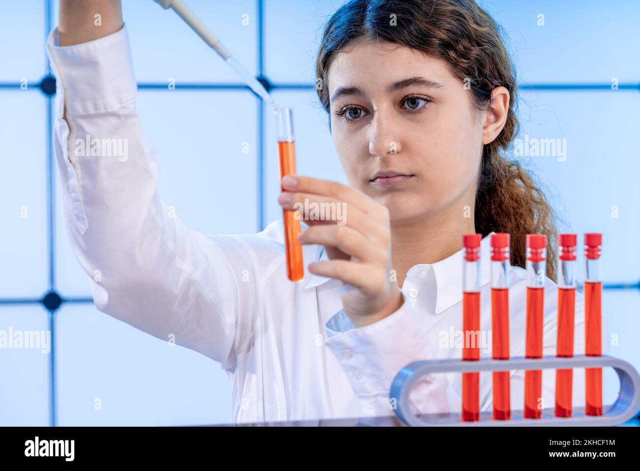 young adult female student in a science laboratory with chemical