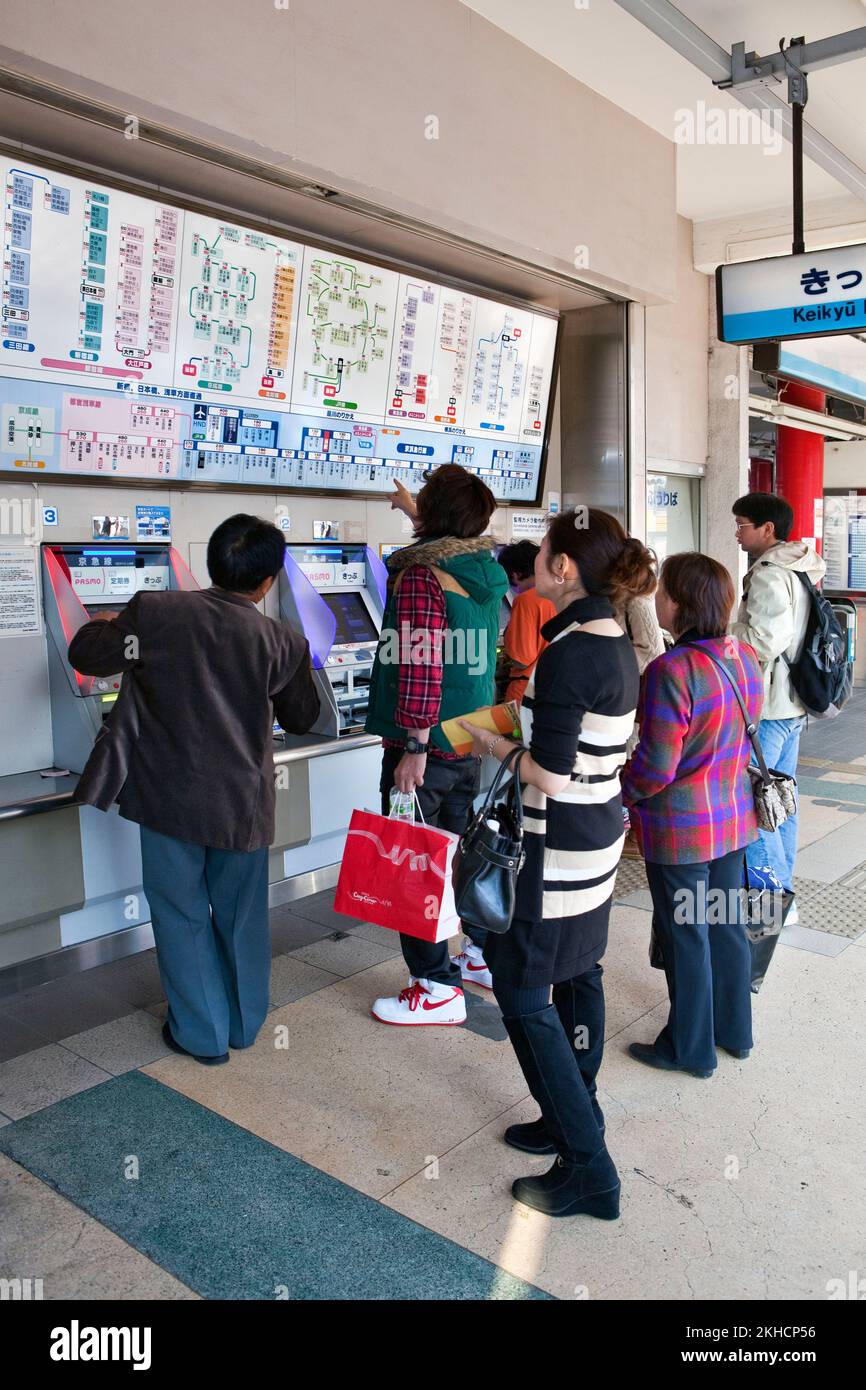 Train passengers ticket machine Kawasaki Japan V Stock Photo