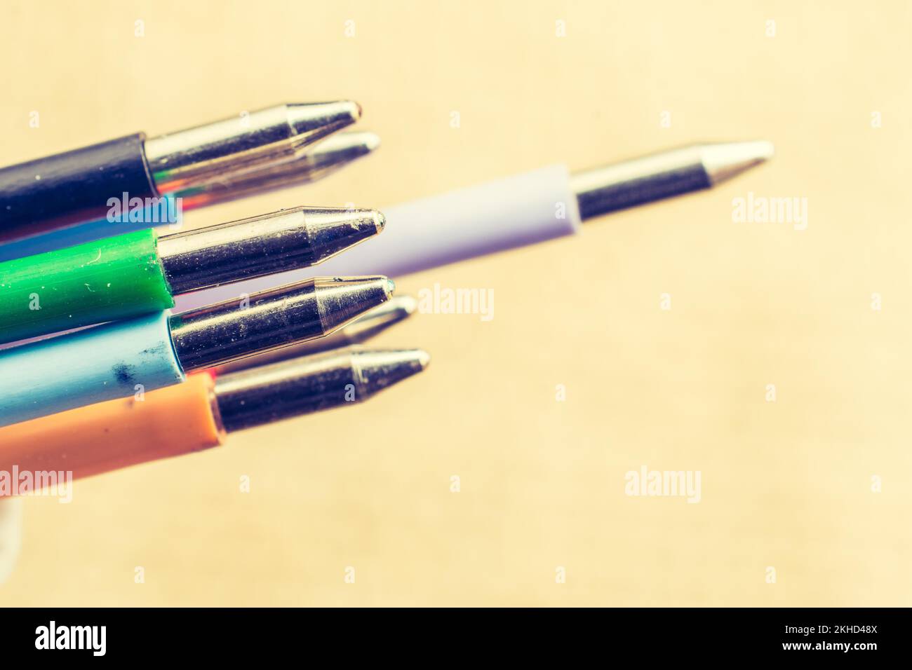 Multi colored pen on a textured background on display Stock Photo