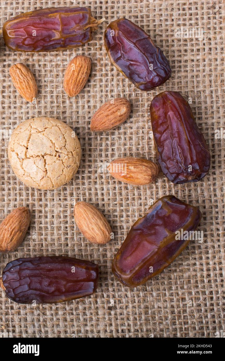 Date fruit, almond and cookies  form the sun shape on canvas Stock Photo