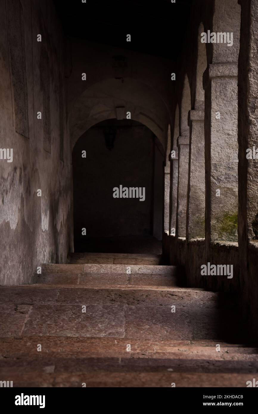 A stairway down stairs with an arch entrance Stock Photo - Alamy