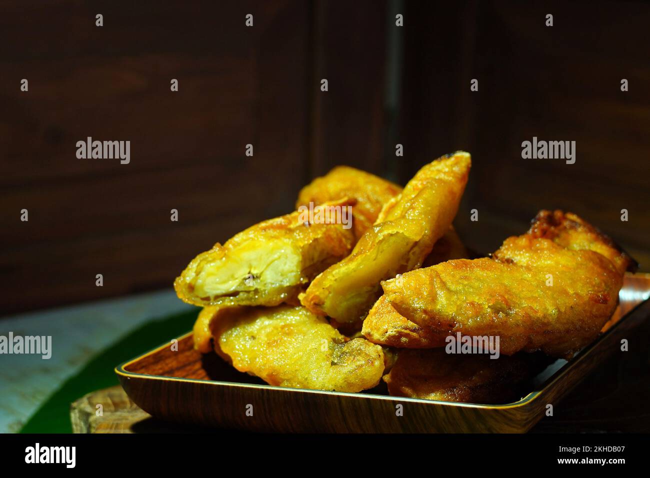 Pisang goreng or banana fritters from Indonesia served in wooden plate