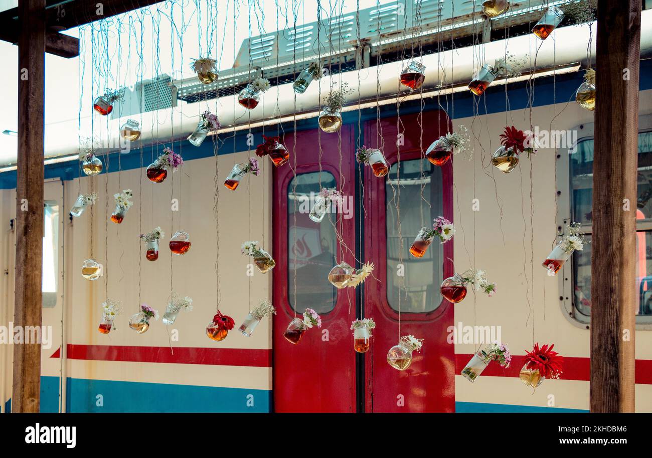 Herbal tea bottle with flowers hanging on string Stock Photo - Alamy