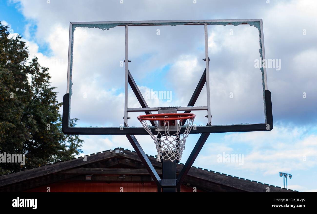 Broken glass backboard and broken hoop on the basketball court Stock
