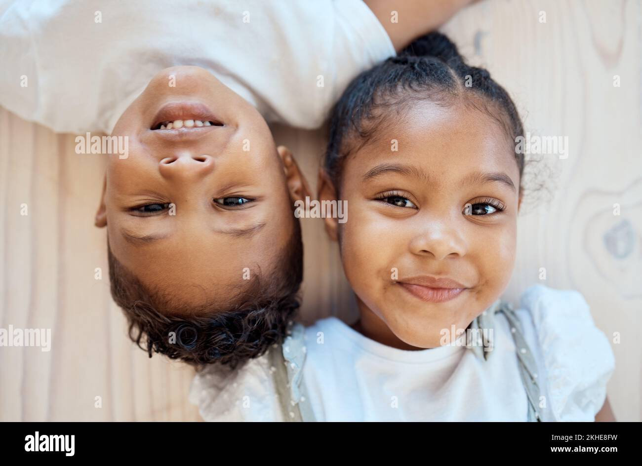 Family friends, smile and children portrait of siblings with happiness, bonding and love at home. Faces of happy kids together above view of brother Stock Photo