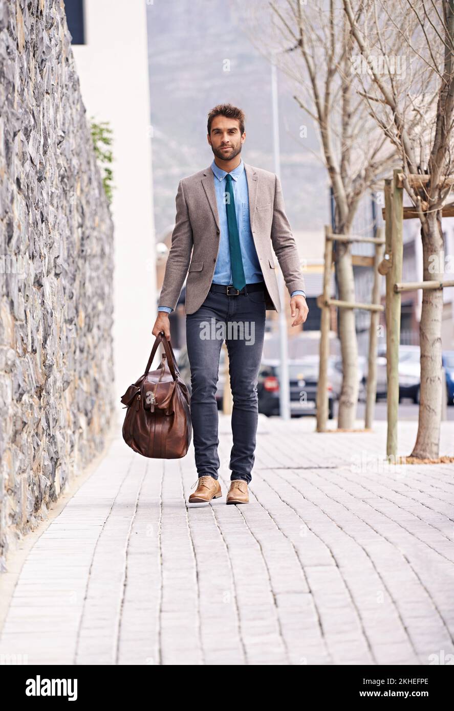 Going places. a handsome and stylish young businessman walking in an urban setting. Stock Photo
